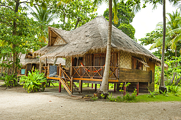 Cottages with thatched roofs and wooden structures in tropical surroundings on Koh Jum Island in Krabi Thailand