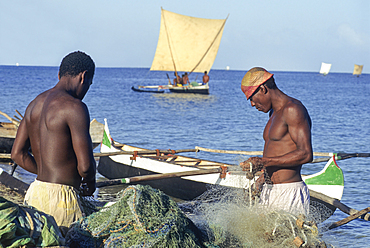 fishermen mending fishing net on a beach of Tulear, Southern Madagascar, Indian Ocean, Southeast Africa