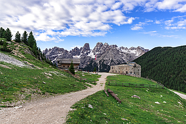 Path leading to Prato Piazza fort and Rifugio Vallandro with mountains in the background in South Tyrol, Italy