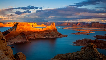 Evening light illuminates rock formations at Alstrom Point over Lake Powell in Utah
