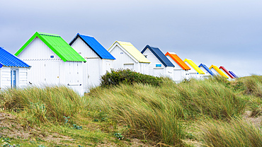 Colourful beach huts on the sandy beach at Gouville-sur-Mer, Manche, Normandy, France