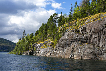 Exploring Lomsdal-Visten National Park in Norway with rugged terrain and clear waters