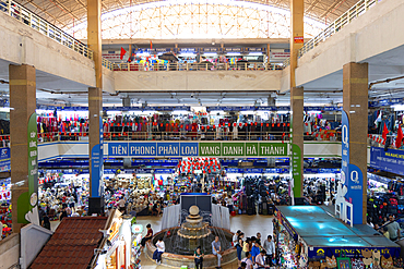 Market scene inside Dong Xuan Market showing stalls and shoppers in Hanoi