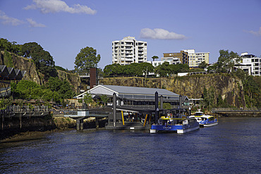 Ferries dock at Story Bridge Ferry Terminal along Brisbane River in Queensland, Australia on a clear day