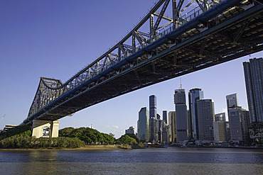 View of Story Bridge spanning Brisbane River with city skyline in background during daytime in Queensland, Australia