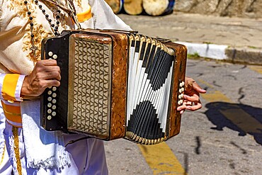 Accordionist with his instrument at the Congado festival in Minas Gerais, Belo Horizonte, Minas Gerais, Brazil