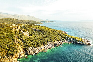 Beautiful aerial drone view Albanian Riviera, rugged mountains, coastal roads, and the crystal clear blue turquoise waters of the Ionian Sea. Mediterranean escape destination. European maldives