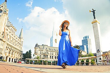 Batumi, Georgia - 7th august, 2025: Elegant excited happy woman sightseeing europe square, visiting Batumi Georgia. Tourists enjoying holiday in Europe famous landmark - Vacation and happy lifestyle