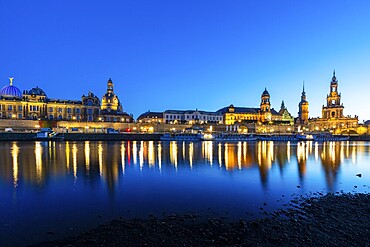 Old town skyline with Br&uuml;hl's Terraces, Kunstakdeimie, Church of Our Lady, Cathedral Sanctissimae Trinitatis, Residenzschloss, Higher Regional Court, paddle steamer on the Elbe in the blue hour, reflection, Dresden, Saxony, Germany