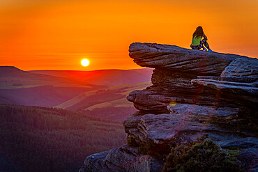 View of young woman on Bamford Edge at sunset, Bamford, Peak District National Park, Derbyshire, England, United Kingdom, Europe