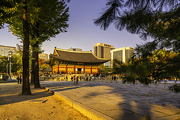 View of Deoksugung Palace with autumn leaves and people enjoying the surroundings in Jung District, Seoul, South Korea
