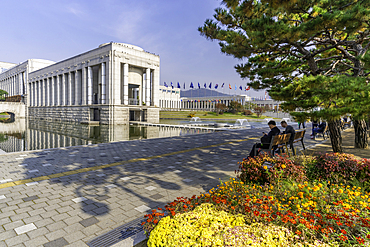 View of the War Memorial of Korea with visitors and colorful flowers on a sunny day in Yongsan District