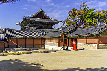 View of Changdeokgung Palace on a sunny day with visitors exploring the historic site in Seoul South Korea