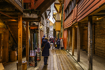 View of narrow wooden walkway through Bryggen in the city of Bergen, Vestland, Norway, Scandinavia, Europe