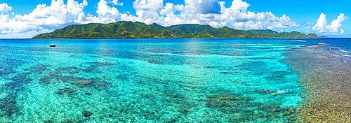 Coral reef with green island on background, Antigua, Caribbean<br />1397-677 Coral reef with green island on background, Antigua, Caribbean