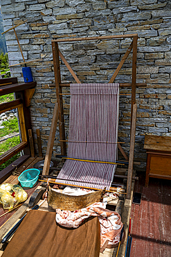 Loom used for weaving textiles in a house in Eastern Bhutan near the window with natural light
