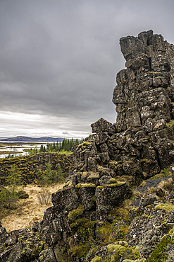 Rock formations at Thingvellir National Park under gray sky in Iceland