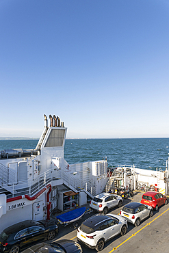 Cars are loaded on the ferry before departure to Broddick on the Isle of Arran in Scotland