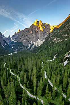 Rocky peak of Cima Una surrounded by green forest, Val Fiscalina, Sesto Dolomites, South Tyrol, Italy