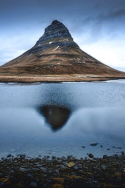 Reflection of the mountain Kirkjufell on the surface of the lake
