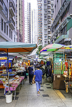 Market stalls in Wan Chai District feature vendors and shoppers in a busy urban setting on Hong Kong Island