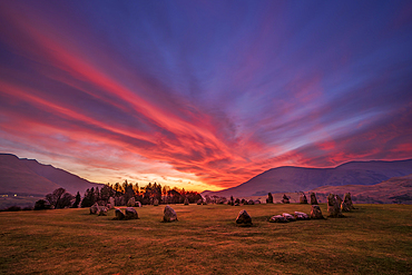 Fiery sunrise over ancient stones at Castlerigg Stone Circle in Lake District, Cumbria