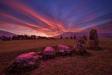 Dramatic sunrise paints the sky above ancient stones at Castlerigg Stone Circle in Lake District, Cumbria